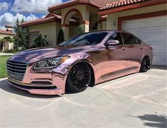 a pink car parked in front of a house