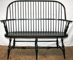 a black bench sitting on top of a white floor