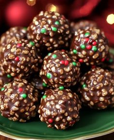 chocolate covered balls on a green plate with christmas lights in the backgroung