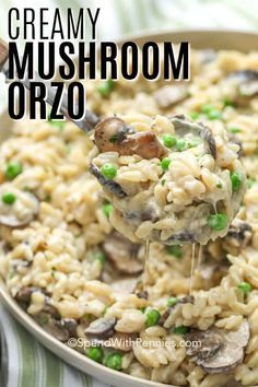 creamy mushroom orzo rice in a skillet with peas and mushrooms being drizzled over it