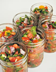 six mason jars filled with different types of salads and veggies in them