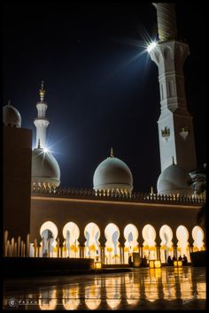 an image of a building that is lit up at night with lights in the background