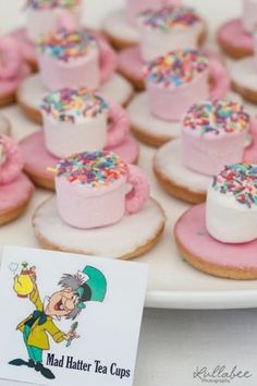 a plate filled with mini marshmallows covered in pink frosting