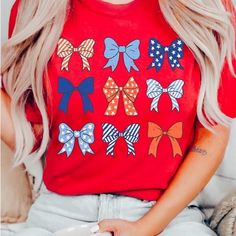 Show Off Your Patriotic Side (With A Touch Of Girly Flair) In Our Red Bow Tee. Adorned With Charming Bows, This Shirt Is Perfect For Celebrating The 4th Of July Or Any Day You Want To Add A Festive Touch To Your Outfit. Multicolor Tops For Holiday And Spring Season, Multicolor Tops For Spring Holiday, Red Short Sleeve Tops For 4th Of July, Patriotic Red Short Sleeve Tops, Fun Red T-shirt For 4th Of July, Red Patriotic Short Sleeve Tops, Red Cotton Top For 4th Of July, Red Cotton Tops For 4th Of July, Graphic Print Top For Spring Holiday