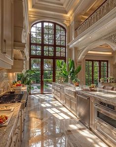 a large kitchen with marble counter tops and white cabinets