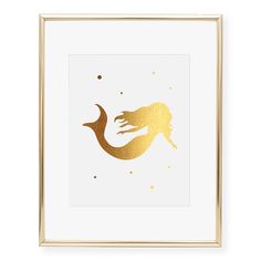 a gold mermaid silhouette in a white frame