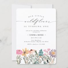 a wedding card with watercolor flowers and the words, our little wildflowers is turning one