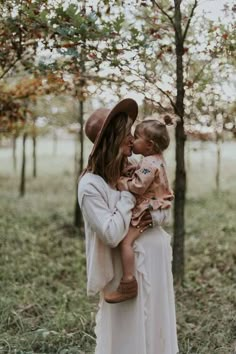 a woman holding a small child in her arms