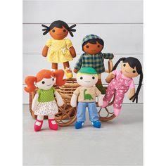 a group of dolls sitting on top of a wooden sled next to each other