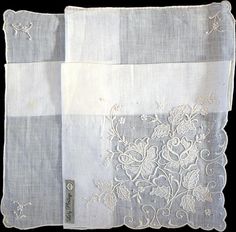 New old stock, never used vintage hanky with fancy and ornate hand embroidery. One corner is heavily embellished with a rose motif, all done in white. This is the perfect bridal accessory for the bride to carry on her wedding day. Hand rolled edges are framed perfectly by embroidered scalloped corners. Made of white linen and measuring 13 inches. Original Lady Heritage tag in tact. Hand made in Madeira, Portugal. Elegant White Floral Embroidered Handkerchiefs, Elegant White Handkerchiefs With Floral Embroidery, Elegant White Handkerchiefs With Machine Embroidery, Formal White Embroidered Handkerchiefs, Vintage Embroidered Handkerchiefs For Wedding, Vintage Embroidered Wedding Handkerchiefs, Vintage Floral Embroidery Wedding Handkerchiefs, Embroidered Cream Handkerchiefs For Wedding, Vintage Wedding Handkerchiefs With Machine Embroidery