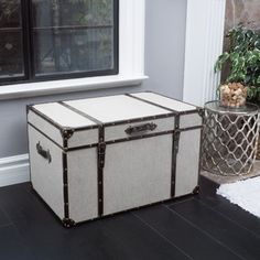 a trunk sitting on the floor next to a window