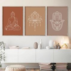 three posters with buddhas and lotuses on them in the living room, one is brown