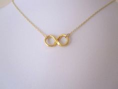 Small INFINITY ETERNITY LOVE in yellow gold plated sterling silver necklace. The Infinity pendant measures 9mm x 20mm Please choose length of the necklace from the drop-down menu.  Lead and nickel free necklace. The necklace comes bubble wrapped and gift wrapped in a complementary organza bag. Symbolic Gold Infinity Jewelry, Symbolic Infinity-shaped Gold Jewelry, Symbolic Infinity Gold Jewelry, Minimalist Gold Infinity Necklace, Minimalist Infinity Gold Necklace, Dainty Gold Infinity Necklace, Gold Infinity Necklace For Gift, Gold Infinity Necklace For Mother's Day, Infinity Pendant