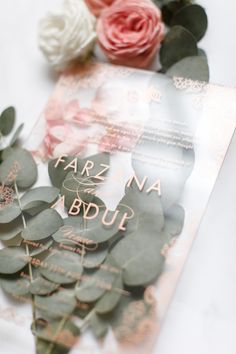 there are some flowers on top of the wedding stationery paper and it's name is farz na bydul