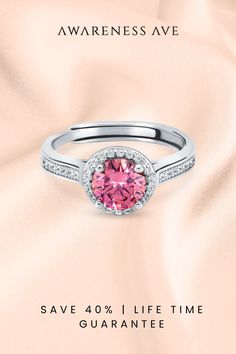 Discover 'The Venus', a captivating pink Moissanite ring that embodies romance. Its S925 sterling silver and exquisite platinum finish promise a lifetime of shine. Perfect for that heartfelt proposal or as a statement of self-love. #PinkRing #EngagementRing #MoissaniteElegance Pink Diamond Halo Promise Ring, Pink Moissanite Diamond Ring With Brilliant Cut, Pink Brilliant Cut Moissanite Diamond Ring, Pink Diamond Ring With Halo Setting, Pink Halo Ring With Center Stone In Round Cut, Pink Diamond Halo Ring As Gift, Pink Diamond Halo Ring With Prong Setting, Pink Halo Diamond Promise Ring, Pink Halo Setting Promise Rings