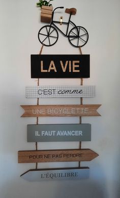 a sign that says la vie on it and is mounted to the side of a wall