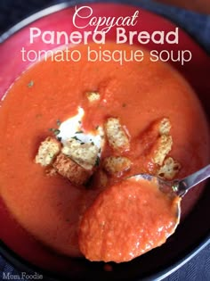 a bowl of tomato bisque soup with bread croutons