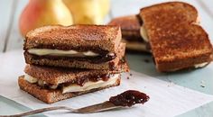 a grilled cheese sandwich with apple jam on the side and a spoon next to it