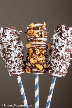 chocolate covered donuts with white frosting and sprinkles are on sticks