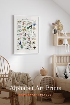 the alphabet art prints are hanging on the wall above a chair and other decor items