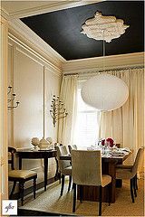 a dinning room table with chairs and a chandelier hanging from the ceiling