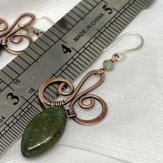 "Oxidized copper wire earrings with beautiful green gemstones for casual and business casual wear. Perfect earth tones:) These earrings are hand forged from copper wire and embellished with green gemstones. They are oxidized and polished to create this nice antique finish which works very well with the green stone. The earrings are finished with Sterling silver ear wire to avoid any allergic reactions one may have to the copper wire. They will be shipped in a little gift box ready to be given aw Unique Hand Forged Green Earrings, Artisan Green Copper Jewelry, Green Wire Wrapped Metal Earrings, Green Bohemian Earrings With Copper Wire, Bohemian Green Earrings With Copper Wire, Green Bohemian Copper Wire Earrings, Earthy Green Wire Wrapped Jewelry, Green Copper Wire Earrings Gift, Hand Forged Green Drop Earrings