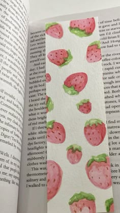 an open book with strawberries on it