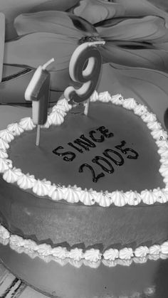 a black and white photo of a cake with the number nine on it