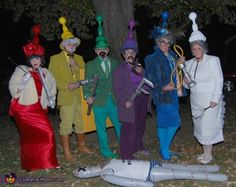 several people dressed in costumes posing for a photo