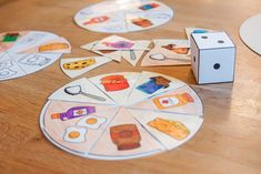 a wooden table topped with cut out pieces of paper