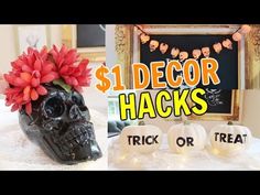 a skull vase with flowers in it sitting on top of a table next to halloween decorations