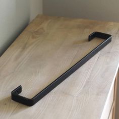 a close up of a wooden counter with a metal handle