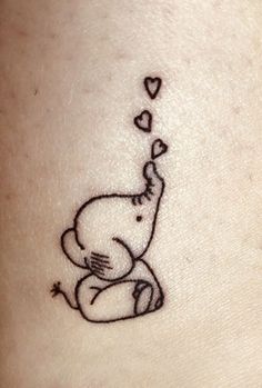 a small elephant with hearts coming out of it's trunk on the back of a woman's stomach