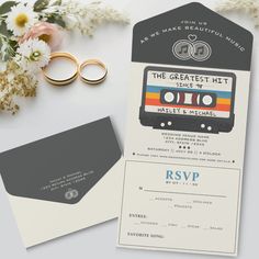 the wedding stationery is set up with two rings and an old - fashioned cassette