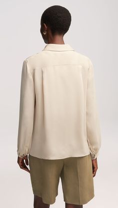 Here’s what happens when an everyday item piece gets an elegant twist. Made of airy Georgette silk, this versatile blouse features bubble sleeves, smart cuffs, and a relaxed fit for effortless layering. Pair with wide-leg trousers, heels, and bold accessories for a classy look that never misses. Casual Beige Blouse With Gathered Sleeves, Elegant Beige Top With Placket Detail, Luxury Beige Relaxed Fit Blouse, Semi-stitched Draped Silk Blouse Piece, Elaine Welteroth, Denim Vests, Bold Accessories, New Career, Everyday Items