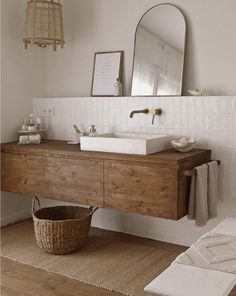 a bathroom with a sink, mirror and rug on the floor in front of it