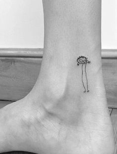 a small flower tattoo on the ankle