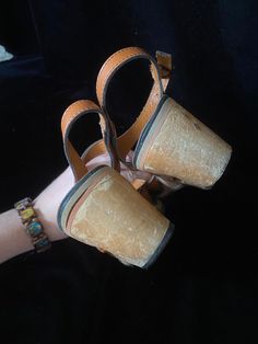 Very funky 1950's brown leather sandals with wooden cut out wedge heels. Bottoms are a soft black material, one shoe is missing a chunk of the soft bottom by the heel, shown in photo. I have not repaired. Wood heels have some scratches. Being sold as is Women's size 5 Vintage Leather Sandals For Beach, Vintage Leather Sandals For The Beach, Vintage Leather Open Toe Sandals, Vintage Brown Closed Toe Sandals, Vintage Ankle Strap Heels With Stacked Heel, Vintage Heels With Stacked Heel And Ankle Strap, Retro Leather Open Toe Sandals, Vintage Brown Sandals With Round Toe, Vintage Sandals Open Toe Medium Width