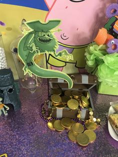 a table topped with lots of gold coins and figurines on top of it