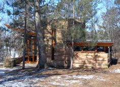 a cabin in the woods with snow on the ground