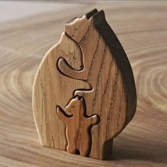 a wooden bear and cub figurine sitting on top of a table