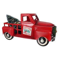 a red truck with a christmas tree in the back