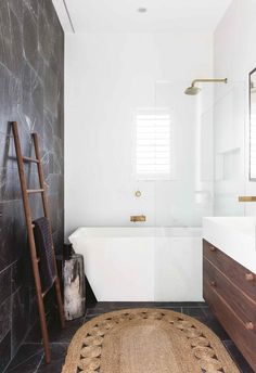 a white bath tub sitting next to a walk in shower