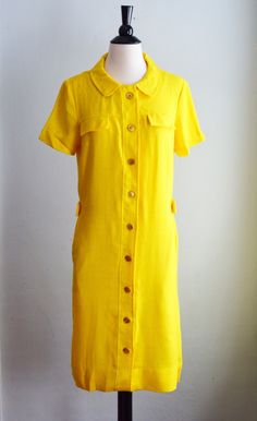 Vibrant 1960's silk blend shift. Sunshine yellow shift with adorable Peter Pan collar and gold buttons from top to bottom. Two faux pockets at the bust, with functional pockets at the hips. Band at the back with buttons at each side. Lightweight silk/rayon blend makes it perfect for spring through summer. In excellent vintage condition. Label Shoulders 15" Bust 38" Waist 28" Hips 36" Length 38" Sunshine Yellow, Pan Collar, Peter Pan Collar, Gold Buttons, Dress Clothes For Women, Peter Pan, Shift Dress, 1960s, Shirt Dress