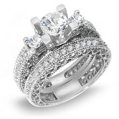 two wedding rings with diamonds on each band and an engagement ring in the middle,