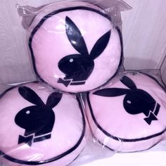 four pink pillows with black bunny ears on them