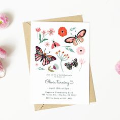 a birthday card with butterflies and flowers on it next to some pink carnations