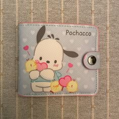 a small wallet with a cartoon character holding two little chicks on it's back