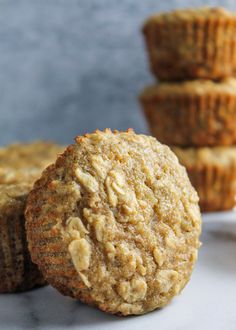 three muffins stacked on top of each other with more muffins in the background