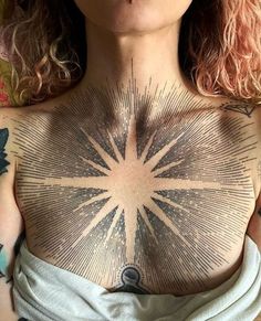 a woman with tattoos on her chest